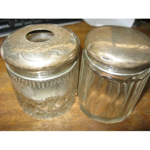 197 - A pair of silver topped antique cut glass pots