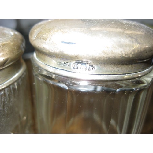 197 - A pair of silver topped antique cut glass pots