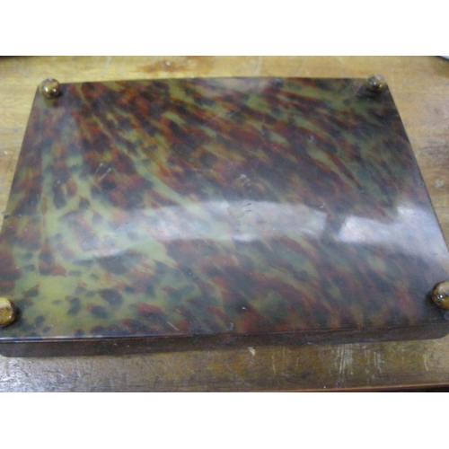 210 - A tortoiseshell effect desk tray on bun feet, possibly tortoiseshell, possibly Bakelite or lucite, w... 