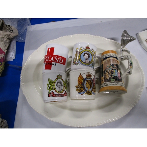 133 - A woods Ivory ware serving dish along with 4 commemorative mugs and a German stein