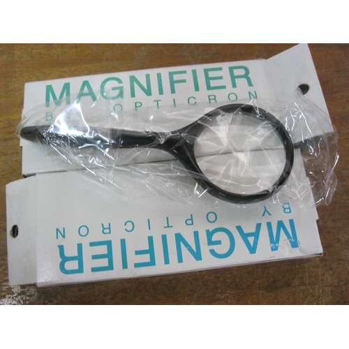 376 - A pair of new and boxed magnifying glasses by Opticron and a larger Magnifier-Lite