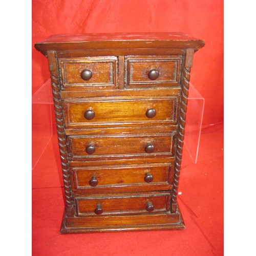 334 - A small wooden cabinet with drawers