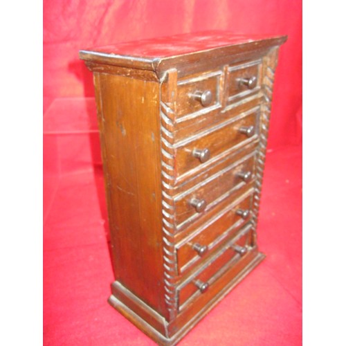 334 - A small wooden cabinet with drawers