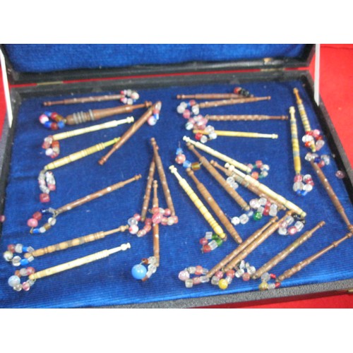 220 - A case of antique vintage bobbins including carved bone examples, all in good order