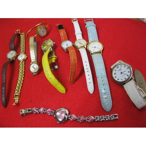 353 - An assortment of ladies watches including at least one bearing the name of a famous fashion brand