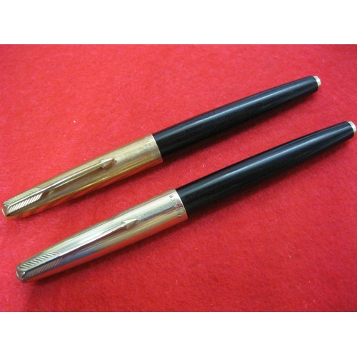 154 - A pair of Parker 61 fountain pens with gold plated caps, one 12ct the other 14ct, one inscribed 'N A... 