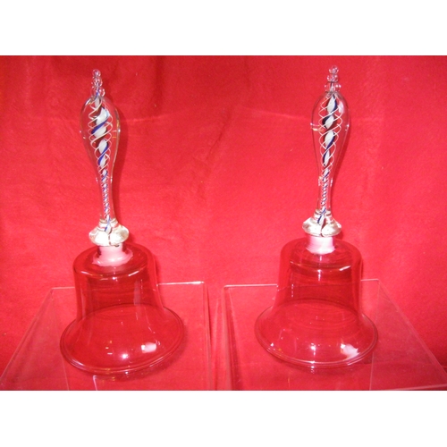 57 - A pair of Victorian cranberry glass bells, the handles ornately wrought with internal red, white & b... 