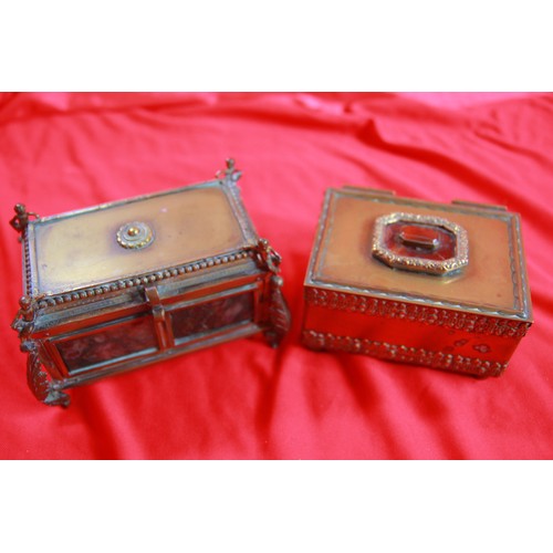 34 - A pair of decorative and heavy brass trinket boxes, one set with a stone to the top, the other with ... 