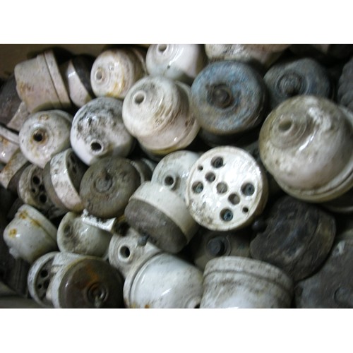 193 - A large assortment of vintage porcelain light switches in an old ammunition case