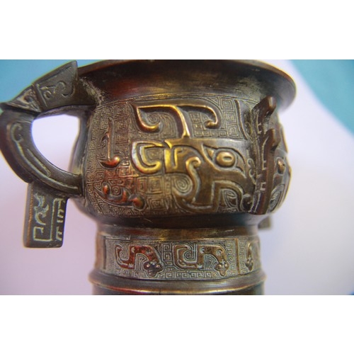 19 - A small 17th-18th century archaistic bronze censer, cast to the exterior with two large taotie masks... 