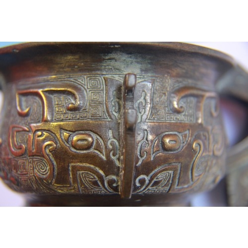 19 - A small 17th-18th century archaistic bronze censer, cast to the exterior with two large taotie masks... 