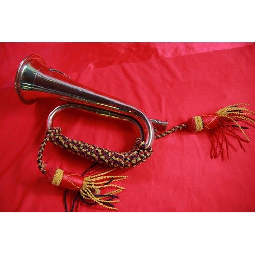 183 - A brass bugle with cords and Royal Artillery Badge