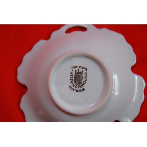 213 - A small leather holder marked Churchill's Club, Bond Street, London containing 4 ashtrays/pin dishes... 