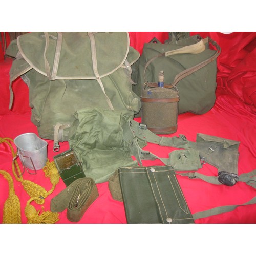184 - A military framed rucksack full of various items of webbing including 58 pattern pistol holster and ... 