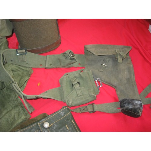 184 - A military framed rucksack full of various items of webbing including 58 pattern pistol holster and ... 