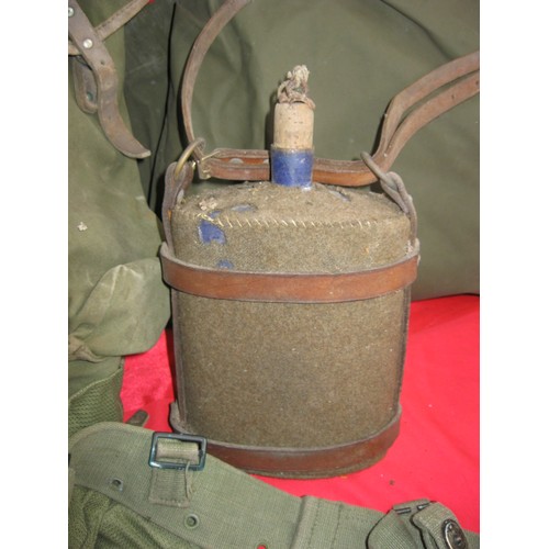 184 - A military framed rucksack full of various items of webbing including 58 pattern pistol holster and ... 