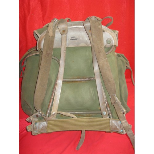 184 - A military framed rucksack full of various items of webbing including 58 pattern pistol holster and ... 