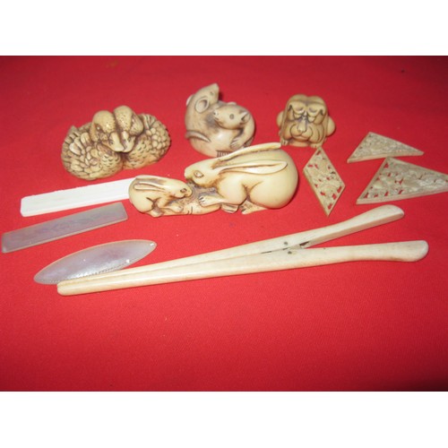 214A - A selection of carved Netsuke figurines comprising mice, rabbits, ducks, a frog plus a pair of carve... 