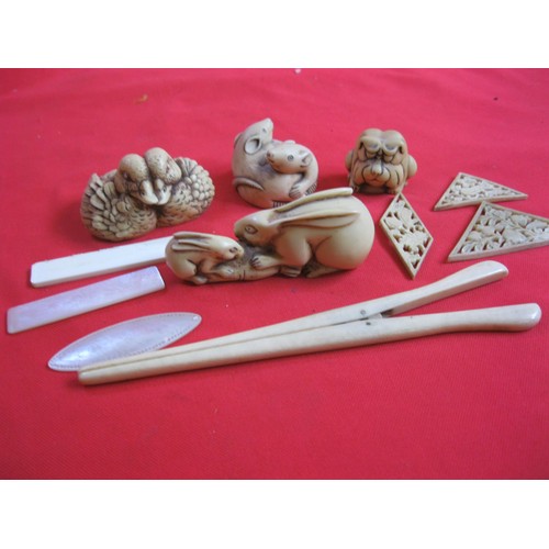 214A - A selection of carved Netsuke figurines comprising mice, rabbits, ducks, a frog plus a pair of carve... 