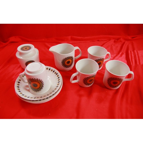 293 - A retro 1960s coffee service comprising 4 floral decorated coffee cans and saucers plus a creamer an... 