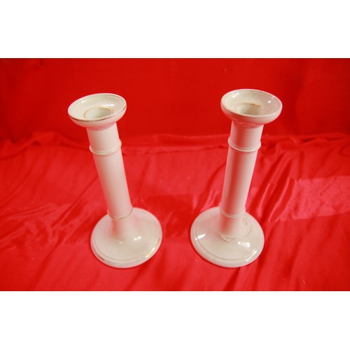 299 - A pair of Edwardian porcelain candlesticks