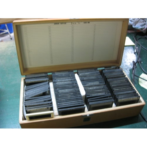 404 - A wooden Johnson 'Sixty Six' slide box containing late 1950s glass slides, full, 100 capacity