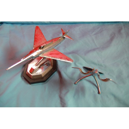 119 - A 1960s chromed desk lighter in the shape of a jet aircraft plus a chromed desk stand in the shape o... 