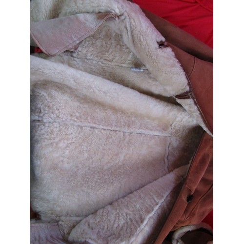 223 - A sheepskin car coat, ladies, in unworn condition, and two matching lined hats