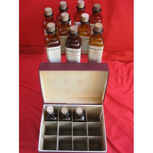 56 - An antique set of 12 apothecaries bottles, all with corks and labels, contained within a partitioned... 