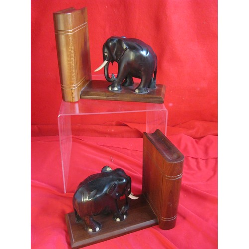 177 - A pair of decorative bookends featuring carved ebony elephants and a carved mahogany book and base, ... 