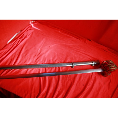 174 - A reproduction officer's sword with metal scabbard and basket hilt, in good order