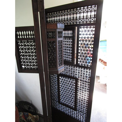 161 - A very large confession screen of carved wood arranged as a room divider, with opening flaps, in ver... 