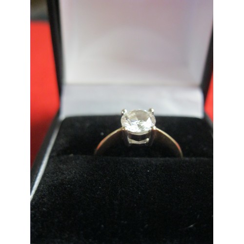 74B - A 9 carat gold solitaire ring with large clear stone, approx weight 2.6g, size O