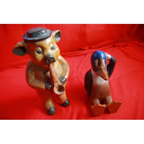 71 - A pair of carved wooden figures, one of a duck, the other of a pig playing a saxophone