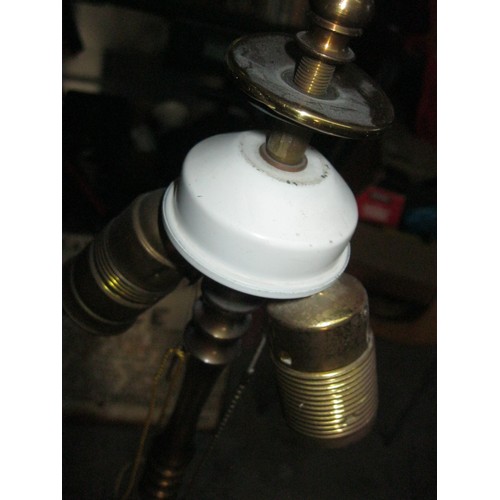 85 - A heavy and tall brass lampstand on tripod feet with shade