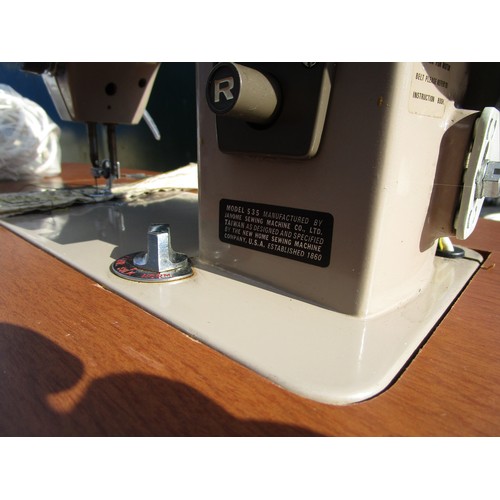 96 - An electric sewing machine built into a flip top table, and two other sewing machines