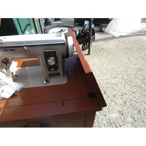 96 - An electric sewing machine built into a flip top table, and two other sewing machines