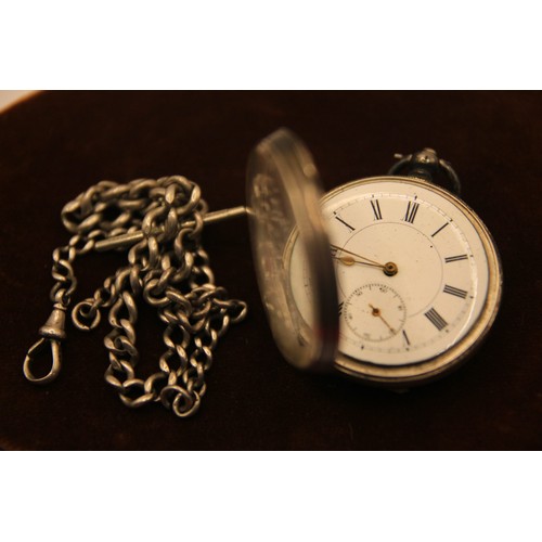 201 - A silver pocket watch in .935 fine silver, key wind and set, mounted on a double Albert chain. The c... 