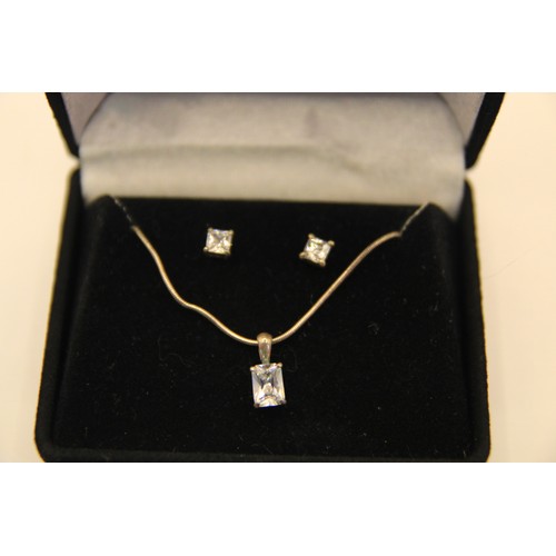 206 - A boxed pair of gem set sterling silver earrrings with a matching pendant on flexi chain