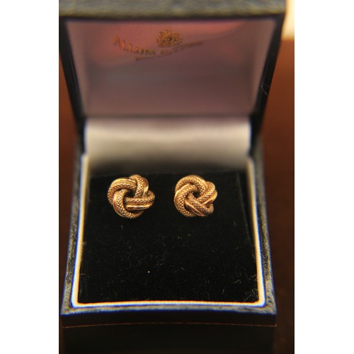 214 - A boxed pair of Turk's Knot style earrings in 9 carat gold, approx weight 2g