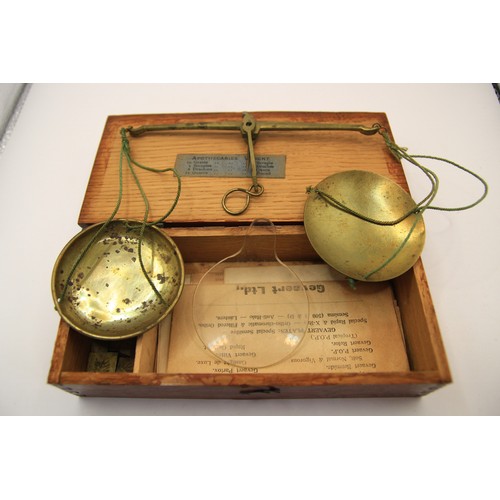 220 - A wooden-cased set of apothecary scales with weights