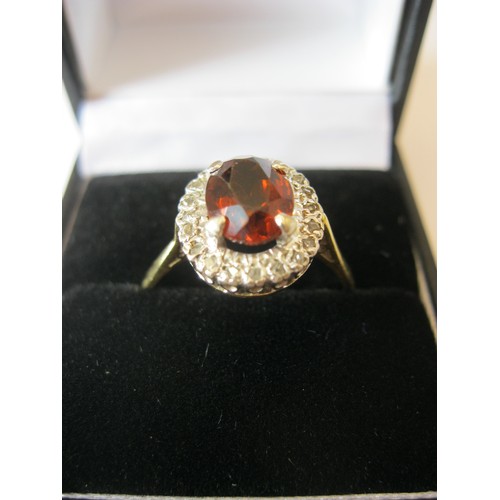 234 - An 18 carat gold ring with very large central ruby surrounded by diamonds, approx weight 4.6g, size ... 