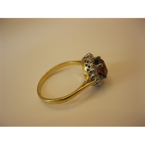 234 - An 18 carat gold ring with very large central ruby surrounded by diamonds, approx weight 4.6g, size ... 