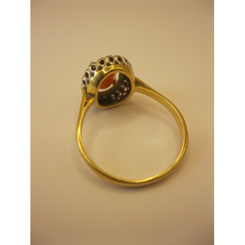 234 - An 18 carat gold ring with very large central ruby surrounded by diamonds, approx weight 4.6g, size ... 