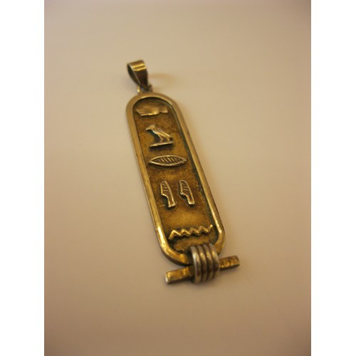 240 - A silver gilt Egyptian pendant featuring heiroglyphs