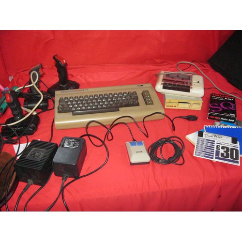 221 - A Commodore 64 vintage home computer system with power bricks, mouse, memory expansion cartridge, ta... 