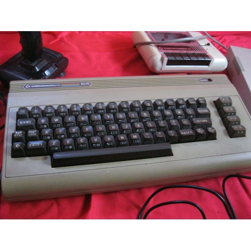 221 - A Commodore 64 vintage home computer system with power bricks, mouse, memory expansion cartridge, ta... 