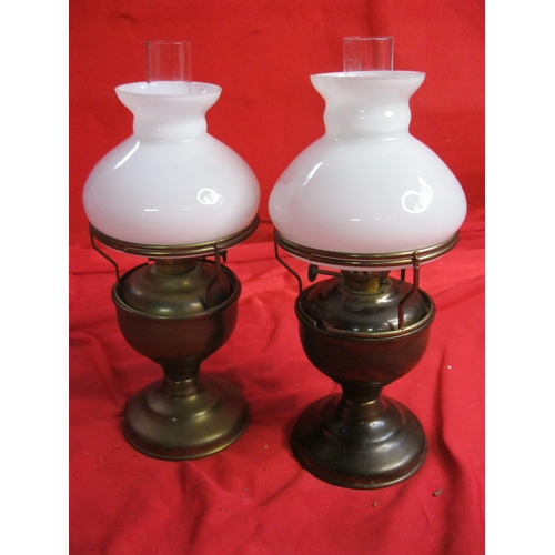 308 - A matching pair of miniature oil lamps with brass bases, glass funnels and milk-glass shades, approx... 