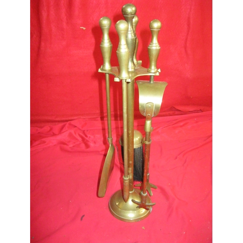 309 - A small brass companion set, complete with stand, in good order