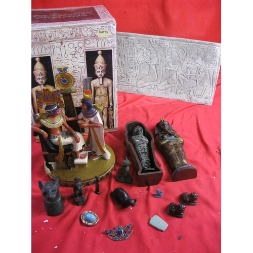 310 - An assortment of Egyptian related items including a boxed figure, sarcophagus with mummy, various ca... 